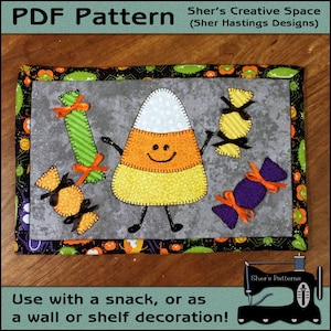 May include: A PDF pattern for a Halloween-themed candy corn character with a smiling face and candy pieces. The pattern is designed for use with a snack or as a wall or shelf decoration.