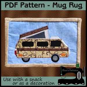 May include: A rectangular fabric mug rug featuring a light blue background and a tan camper van with brown scrollwork patterns. The van has a pop-up roof, black windows, and dark wheels. The piece is finished with a tan border and text reading PDF Pattern - Mug Rug and Use with a snack or as a decoration.