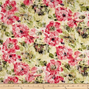 May include: A close-up of a fabric with a floral pattern. The fabric is a light cream color with pink and green flowers. The flowers are in a variety of sizes and shapes. The fabric has a textured surface.