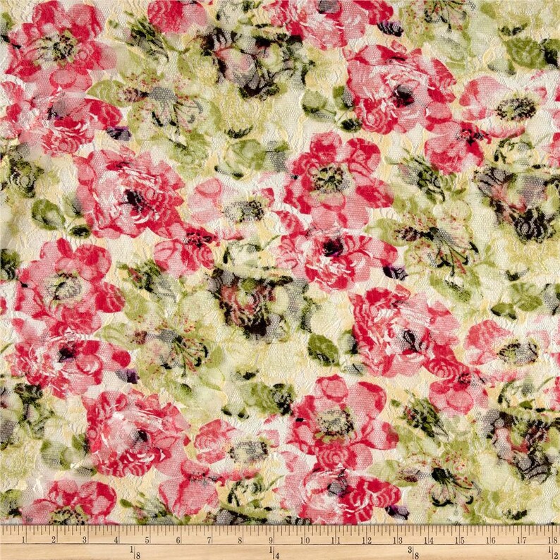 May include: A close-up of a fabric with a floral pattern. The fabric is a light cream color with pink and green flowers. The flowers are in a variety of sizes and shapes. The fabric has a textured surface.