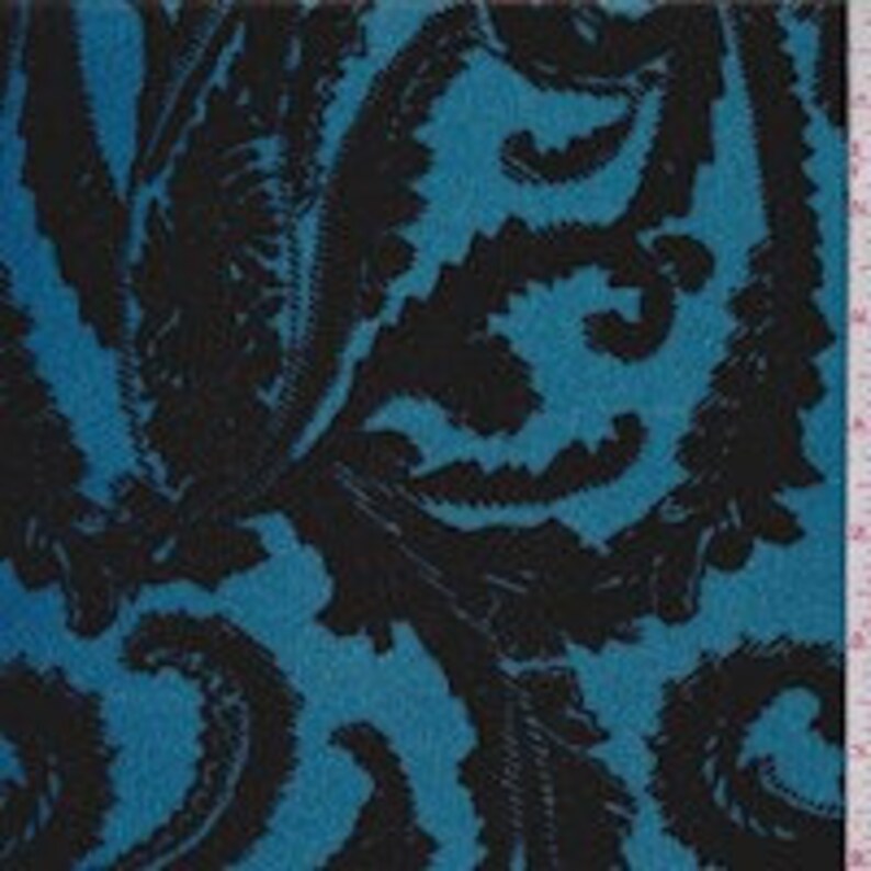 May include: Teal blue fabric with a black paisley pattern.