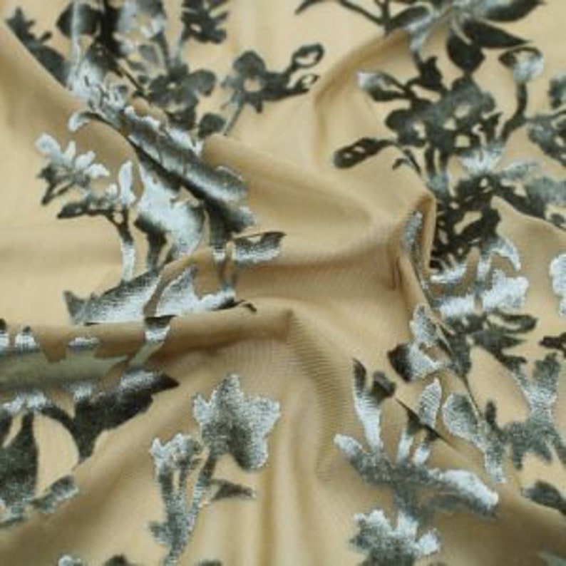 May include: Beige fabric with a green floral velvet pattern.