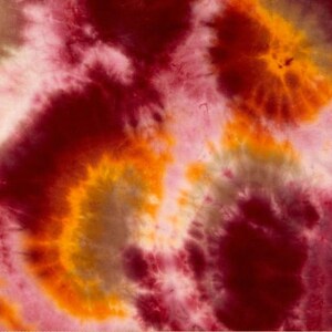 May include: Abstract tie-dye pattern in shades of red, orange, yellow, and white. The colors swirl and blend together to create a unique and eye-catching design.
