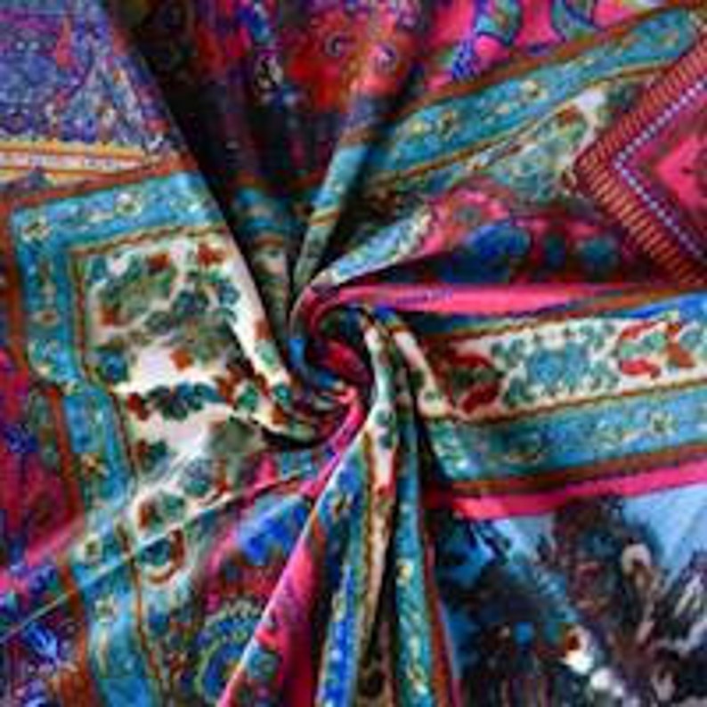 May include: A colorful fabric with a paisley pattern in shades of pink, blue, green, and brown. The fabric is folded and twisted, showing the intricate details of the design.