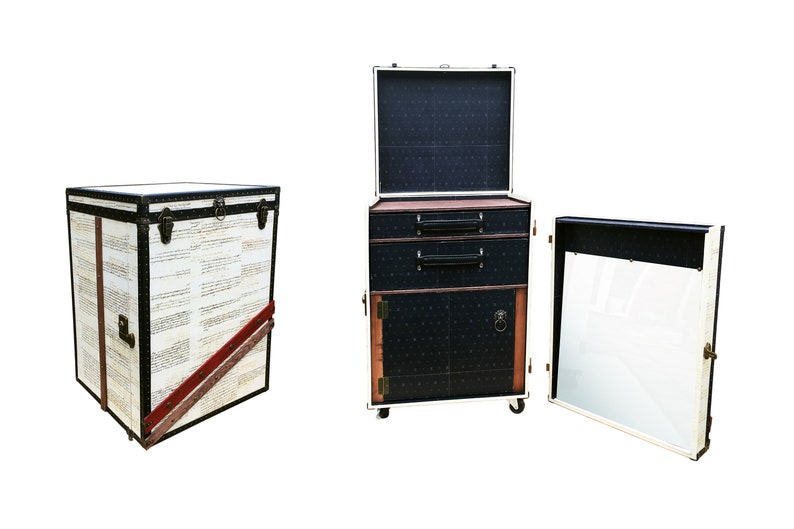 May include: Three vintage-style suitcases with black and white patterned exteriors. The suitcases have brass hardware and are arranged in a row. The suitcase on the left is closed, the middle suitcase is open with two drawers and a door, and the suitcase on the right is open with a mirror inside.