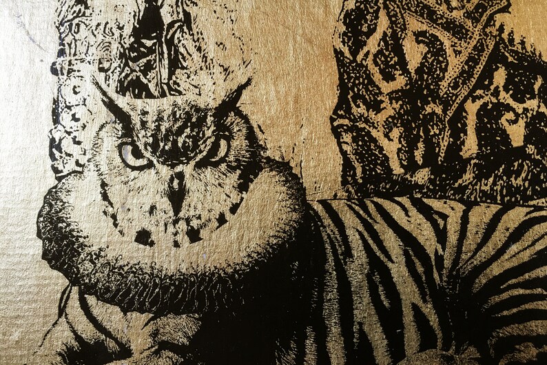May include: A black and white image of an owl with a gold background. The owl's eyes are wide open and staring directly at the viewer. The owl is partially obscured by a black and white striped pattern.