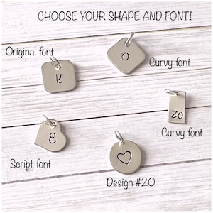 May include: Five metal charms with different shapes and fonts. The charms are a square, a heart, a circle, and two rectangles. The text on the charms reads "K", "O", "ε", "20", and a heart symbol. The text "Choose your shape and font!" is at the top of the image. The text "Original font", "Curvy font", "Script font", and "Design #20" are below the charms.