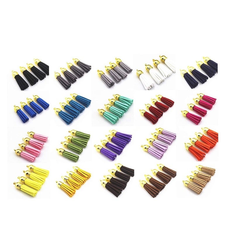 May include: A set of 24 small tassels in various colors, including black, white, gray, blue, green, pink, purple, red, orange, yellow, brown, and beige. Each tassel has a gold metal loop at the top.