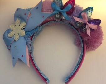 Pom pom holiday headband with snowflake bow