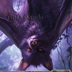 May include: A purple bat token creature card with the text "BAT" at the top and "Token Creature - Bat" and "1/1" at the bottom. The card also has the text "Flying" in a grey box.