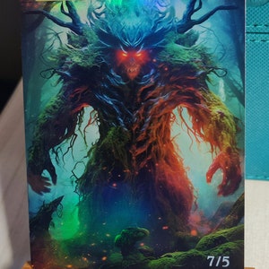 May include: A fantasy art card featuring a large, green, and red creature with glowing red eyes. The card has a holographic finish and the text "ORIGINAL CARD USED FOR THIS ALTER" at the top. The bottom right corner of the card has the number "7/5" printed on it.