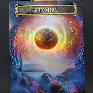 May include: A fantasy card game card with a swirling, glowing orb in the center. The card is titled "STORM" and has the text "Art by Vasyline" and "GnD Cards" at the bottom.