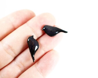 Modern black bird earrings designed as symbolic studs with a poetic shape