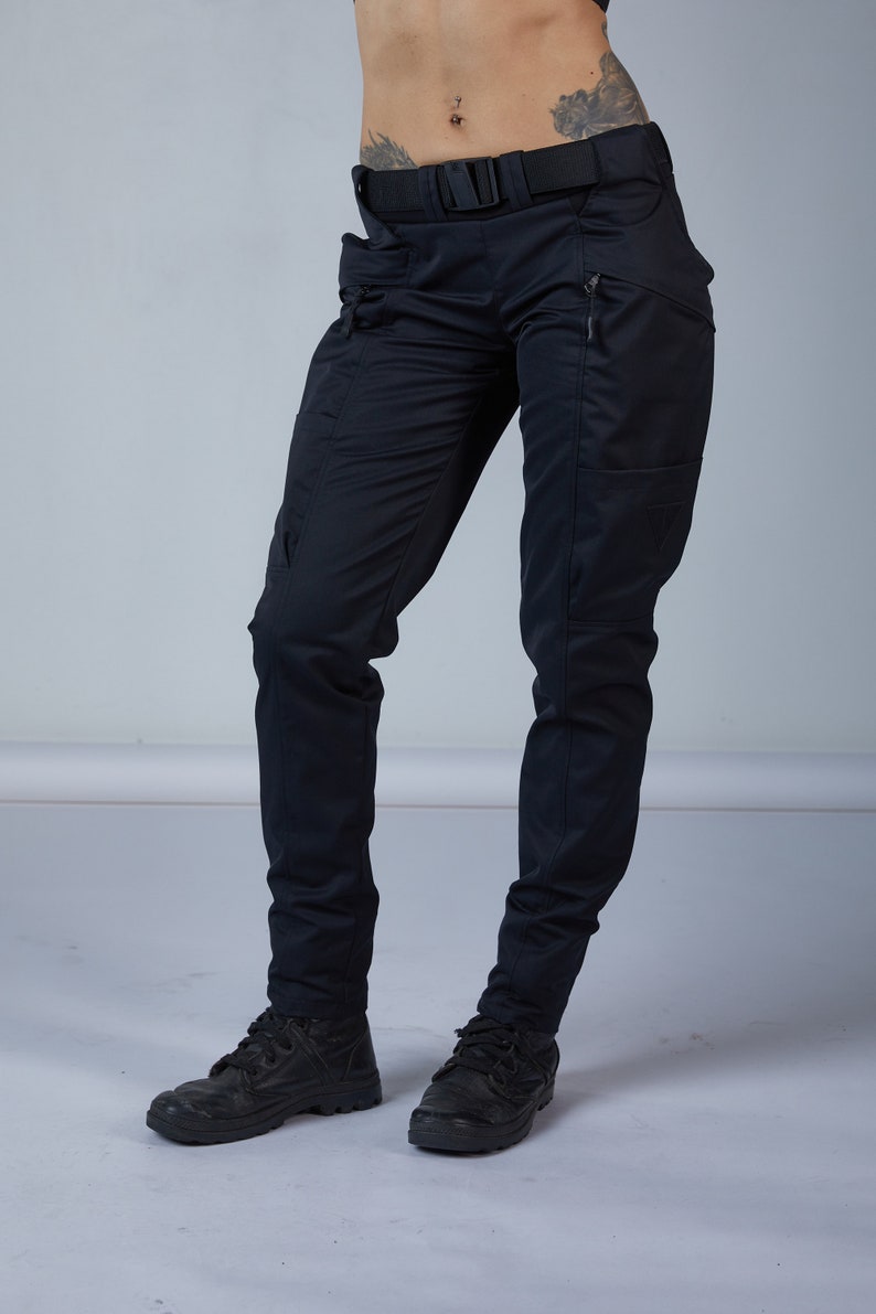 May include: Black cargo pants with a black belt and zippered pockets.