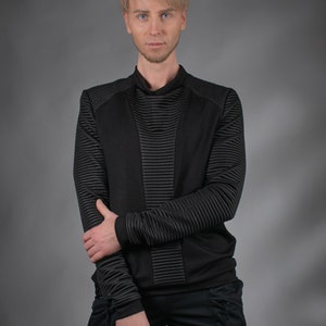 Man in black SP sweater with ribbed sleeves, front view – futuristic menswear