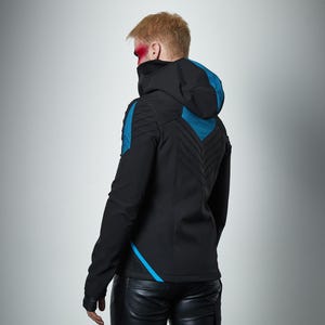 May include: A black hooded jacket featuring teal blue accents on the shoulders and back. The jacket includes a high collar, long sleeves, and a chevron-patterned quilted design on the back panel. The garment is paired with black trousers.