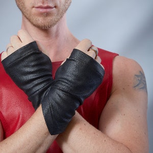 Man in red top with black faux leather fingerless gloves, cyberpunk accessory