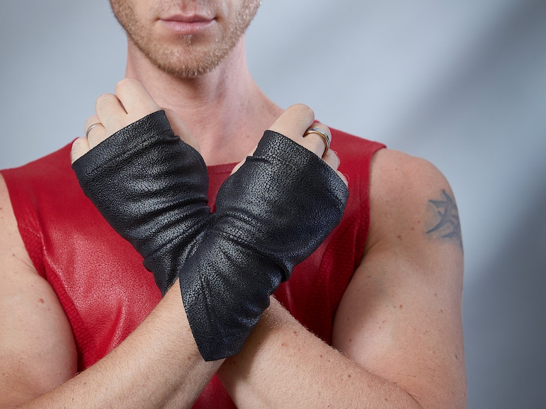 Man in red top with black faux leather fingerless gloves, cyberpunk accessory