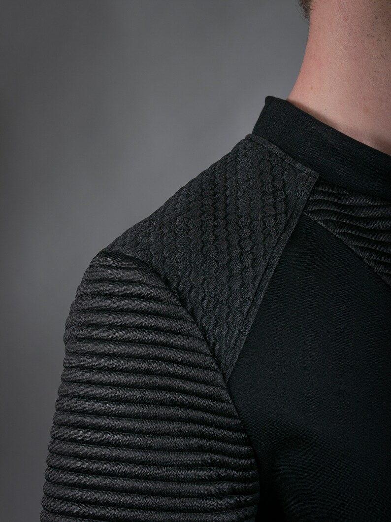 Black SP sweater ribbed shoulder and quilted texture, close-up
