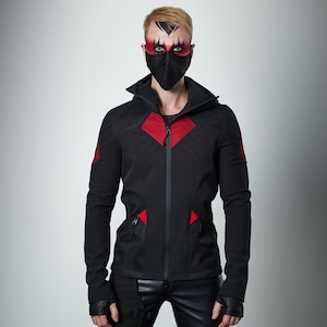 May include: A black hooded jacket featuring red mesh accents on the chest and shoulders, a full-length front zipper, and two zippered pockets. The jacket has long sleeves with thumb holes and is paired with black fingerless gloves and black pants.