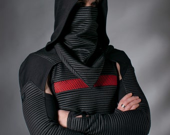 May include: A black hooded top featuring a ribbed texture, long sleeves with thumb holes, and a matching face mask. The garment includes a horizontal red mesh stripe across the chest, providing a distinct contrast against the dark fabric.