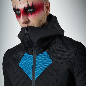 May include: A black zip-up jacket featuring a high collar, a hood, and bright blue mesh panels on the chest and shoulders. The garment includes quilted detailing on the sleeves and torso, with a central zipper closure extending to the neck.