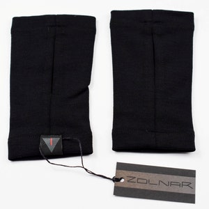 May include: A pair of black arm warmers with a small black triangle logo on one of the warmers. A black and brown tag with the word "ZOLNAR" is included.