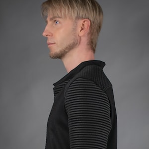 Man in black SP sweater, side profile