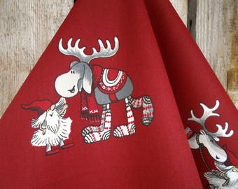 May include: Red fabric kitchen towel with a white and gray moose, a white and gray reindeer, and a white gnome with a red hat.