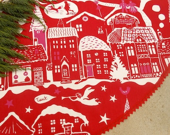 May include: Red fabric with a white design of a winter village with houses, trees, and stars. The fabric has a scalloped edge and the text "Tuut" is printed on the fabric.