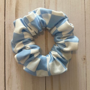 May include: A blue and white checkered scrunchie made of fabric.
