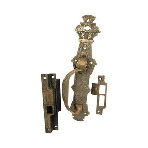 May include: Antique brass door latch with ornate design and a decorative handle. The latch has a keyhole and the text "O. & J. Co." is engraved on the front.