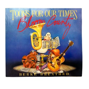 Pode incluir: Uma capa de álbum quadrada com o título "Toons For Our Times Bloom County" e o nome do autor, Berke Breathed. A arte da capa apresenta personagens de desenhos animados tocando instrumentos musicais em um fundo azul.