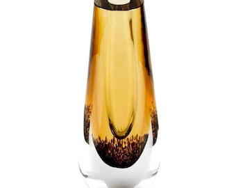 May include: A small, amber glass vase with a clear glass base. The vase has a rounded, teardrop shape and a textured, speckled design.