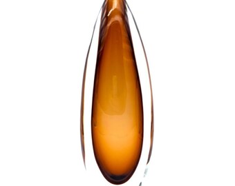 May include: A tall, amber glass vase with a clear glass outer layer. The vase has a rounded, teardrop shape.