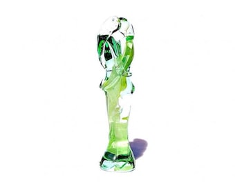 May include: A green glass sculpture of two figures intertwined. The sculpture is abstract and has a modern design.