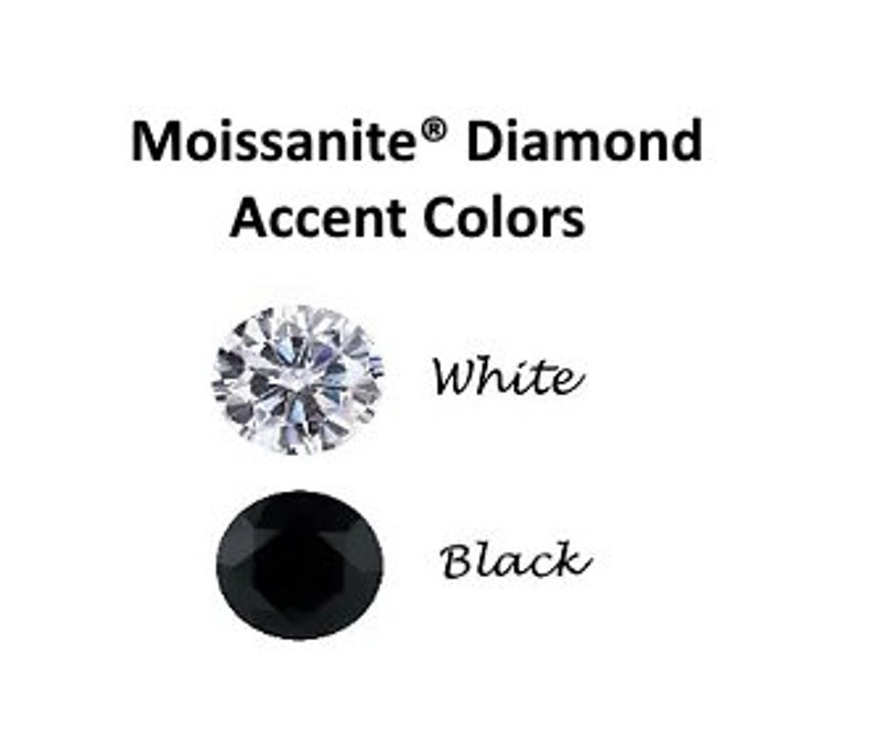 May include: Two round gemstones, one white and one black. The white gemstone is a moissanite diamond, and the black gemstone is a black diamond. Both gemstones are set in a silver setting.
