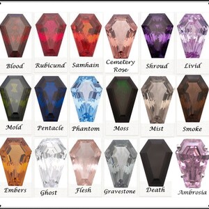 May include: A set of 18 coffin-shaped glass beads in various colors, including blood red, rubicund, samhain orange, cemetery rose, shroud purple, livid purple, mold green, pentacle blue, phantom blue, moss green, mist gray, smoke brown, embers orange, ghost white, flesh pink, gravestone gray, death black, and ambrosia pink.