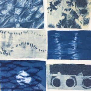 May include: Six fabric squares in various shades of blue with different tie-dye patterns. The fabric is a light blue denim.