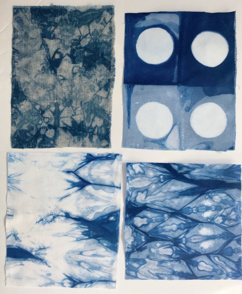 May include: Four fabric squares with different blue dye patterns. The top left square has a blue and white abstract pattern. The top right square has two rows of two white circles on a blue background. The bottom left square has a blue and white abstract pattern with a white background. The bottom right square has a blue and white abstract pattern with a white background.