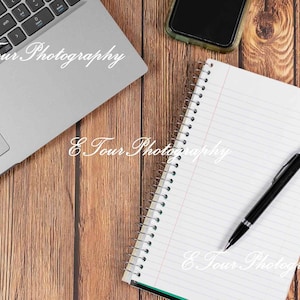 Wooden office desk with notebook and laptop stock photo