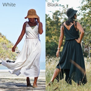 May include: Two women wearing the same style dress, one in white and one in black. Both are wearing straw hats and have their hair pulled back. The woman in white is standing on a beach, while the woman in black is standing in a field of grass.