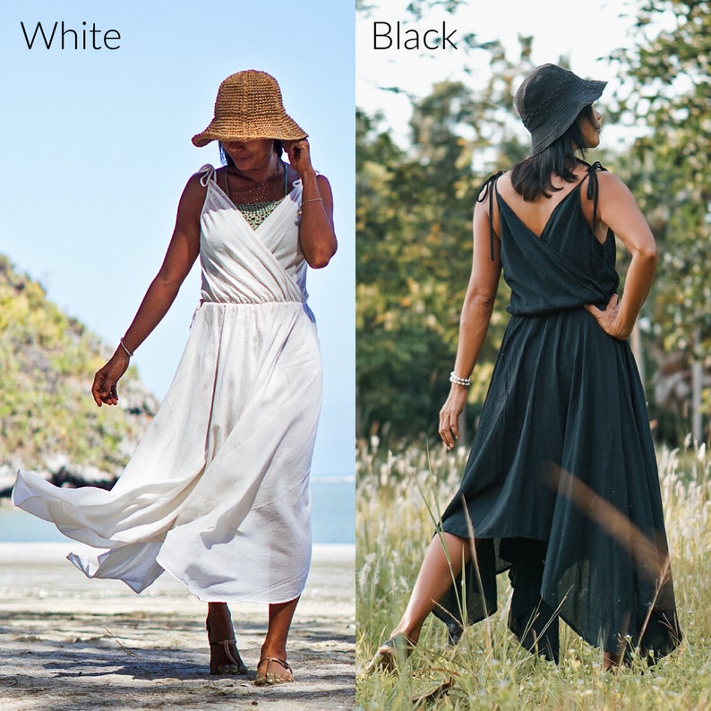 May include: Two women wearing the same style dress, one in white and one in black. Both are wearing straw hats and have their hair pulled back. The woman in white is standing on a beach, while the woman in black is standing in a field of grass.