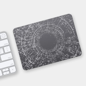 May include: A gray mouse pad with a white circular design that resembles a tunnel or vortex. The design is made up of lines and squares.
