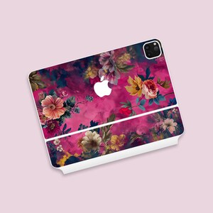 May include: A pink and white phone case with a floral design. The case has a white border and a white Apple logo.