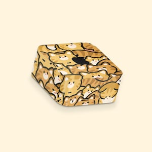 May include: A yellow and brown patterned skin for an Apple TV 4K, featuring a repeating design of cartoon cats.