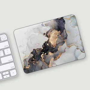May include: Abstract marble design laptop skin with gray, black, and gold swirls.