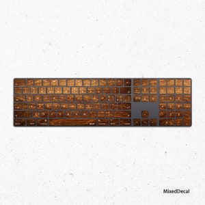 May include: A wooden keyboard skin decal for a wireless keyboard. The decal features a wood grain pattern with a brown and tan colour scheme.