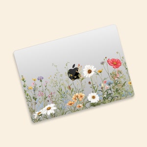May include: A laptop skin with a floral design featuring a variety of colorful flowers, including daisies, roses, and wildflowers, on a white background.