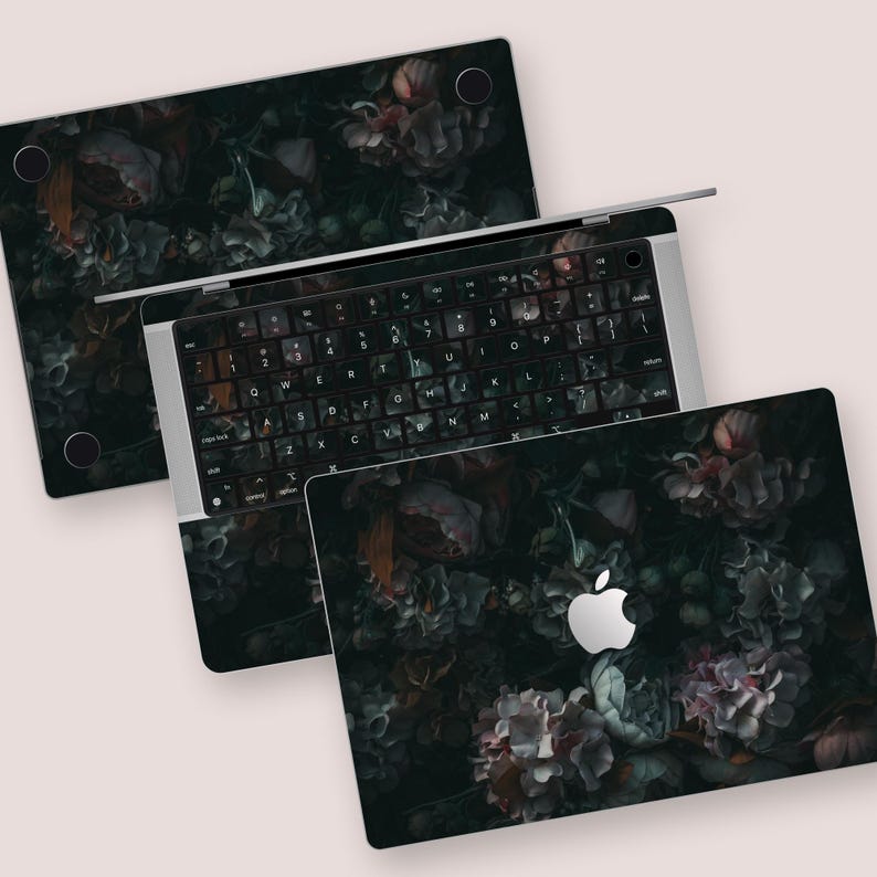 a set of three laptops with flowers on them
